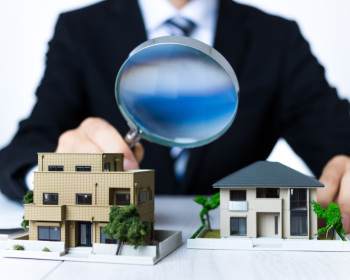 Businessman in a suit to assess the housing